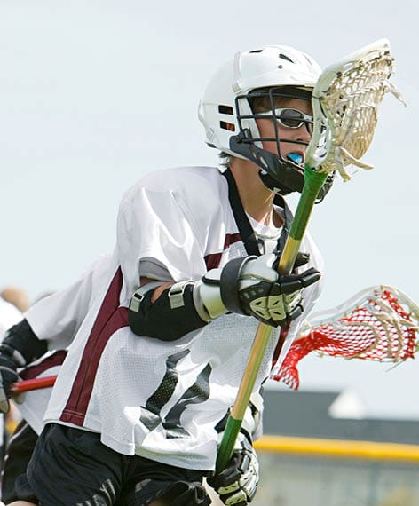 Young lacrosse player in action on the field