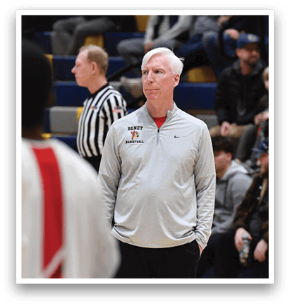 A group of men wearing red and white uniforms stand on a basketball court. They are watching a referee make a call during a game. AI generated content