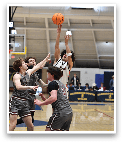 A group of men playing basketball, with one man attempting to block a shot. AI generated content