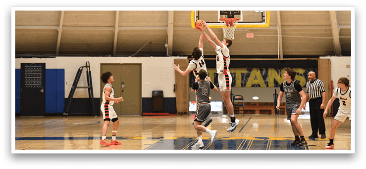 Basketball players on a court, one of them jumping to block a shot. AI generated content