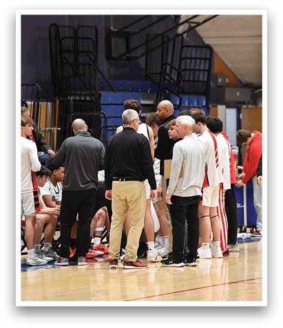A group of men are standing on a basketball court, engaged in a conversation. AI generated content