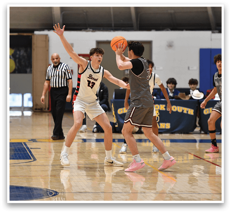 A group of young men playing basketball on a court. One player is attempting to block a shot. AI generated content