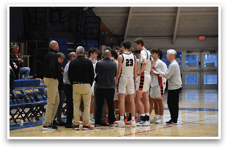 A group of men are standing on a basketball court, engaged in conversation. AI generated content
