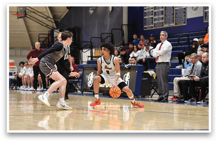 A basketball player is dribbling the ball while another player tries to block him. The scene takes place in a gym with several people watching. AI generated content