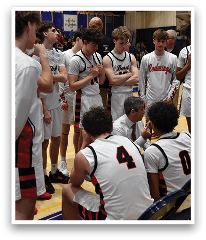 A group of young men wearing red and white uniforms are sitting on chairs. AI generated content