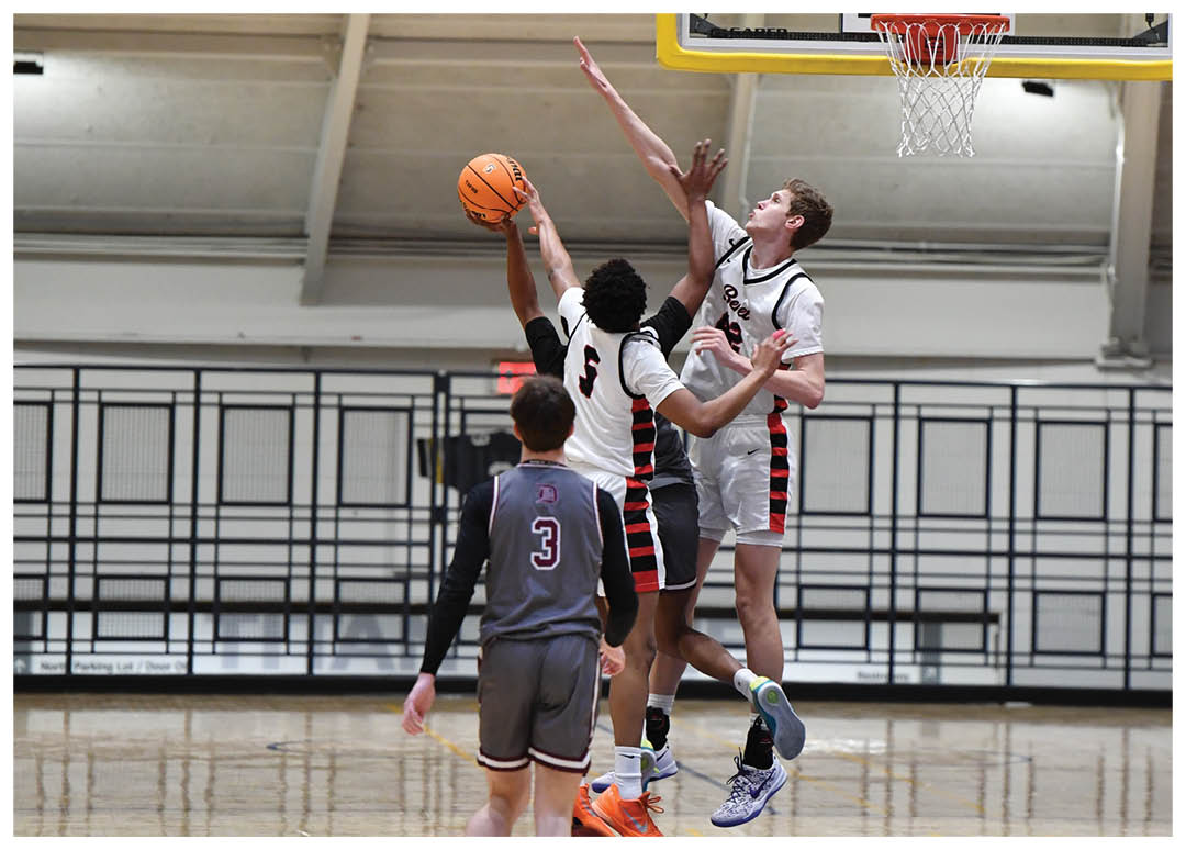 Two basketball players are leaping in the air to reach the ball. AI generated content