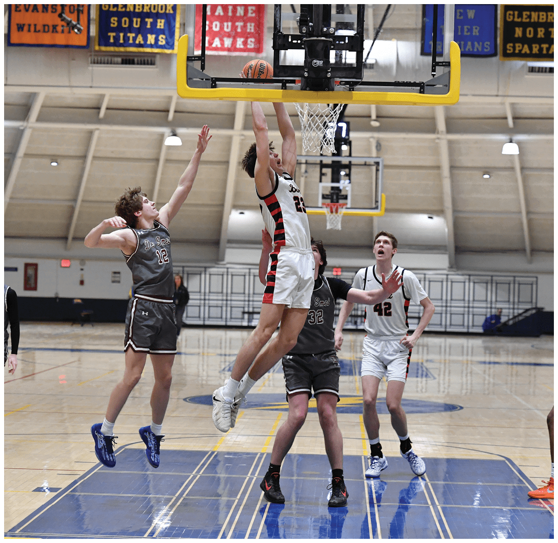A group of young men playing basketball, with one player jumping to block a shot. AI generated content
