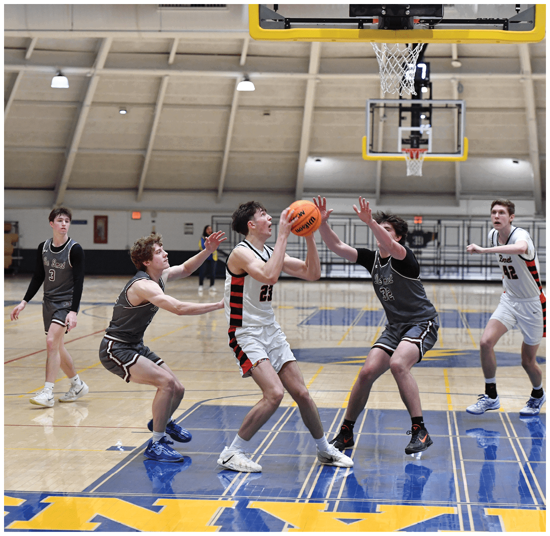 A group of young men playing basketball on a court. AI generated content