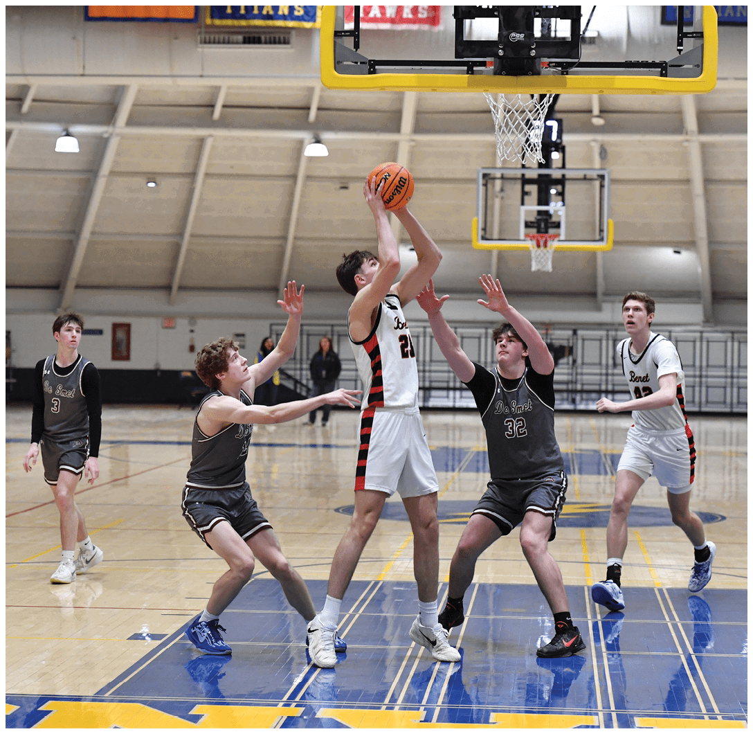 A group of young men playing basketball, with one player attempting to block a shot. AI generated content