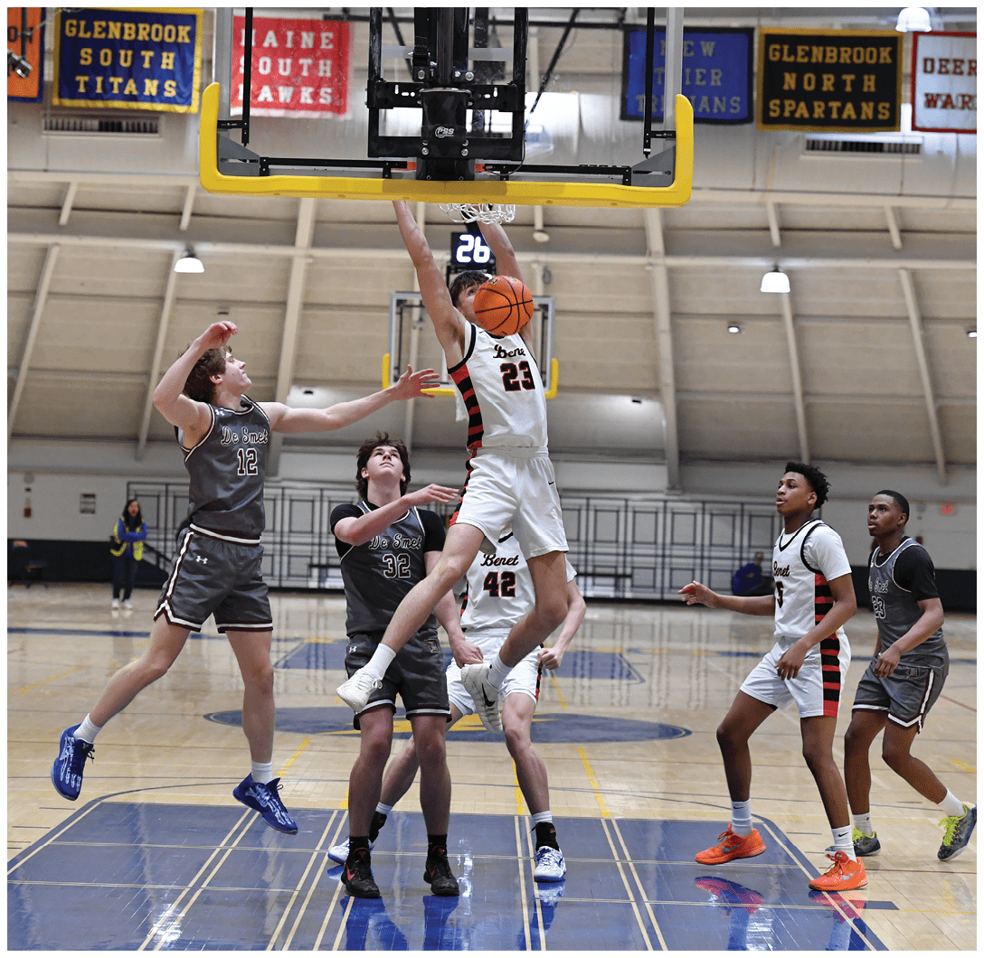 A basketball player is jumping to block a shot, while other players are trying to get the ball. AI generated content