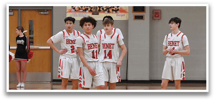 A group of basketball players are standing on the court, some wearing red and white uniforms. They are waiting for the game to start. AI generated content