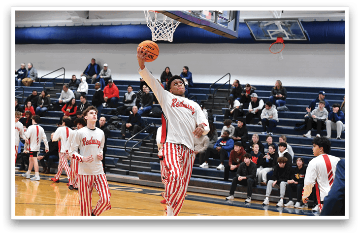 A basketball player in a red and white striped uniform is reaching up to shoot a basket. AI generated content