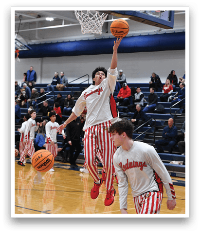 Two basketball players are leaping in the air to reach for the ball. AI generated content