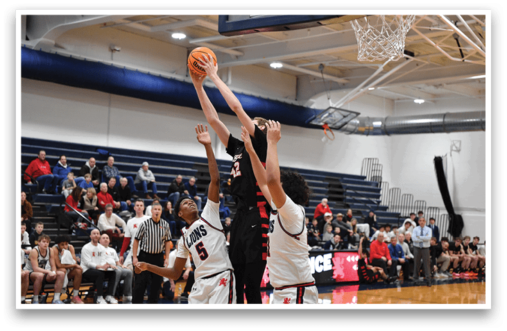 Basketball players are on the court, with one player attempting to block a shot. AI generated content