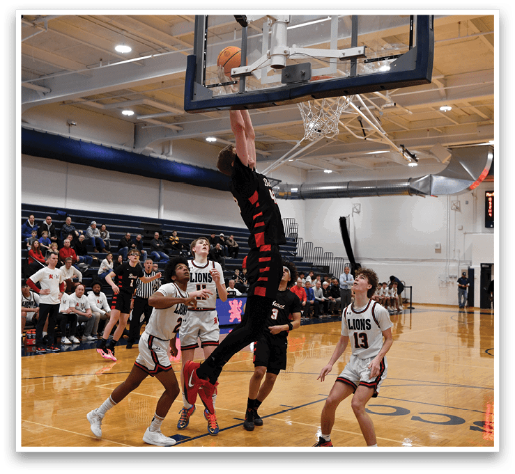 A basketball player leaps to block a shot, while the opposing team tries to score. AI generated content