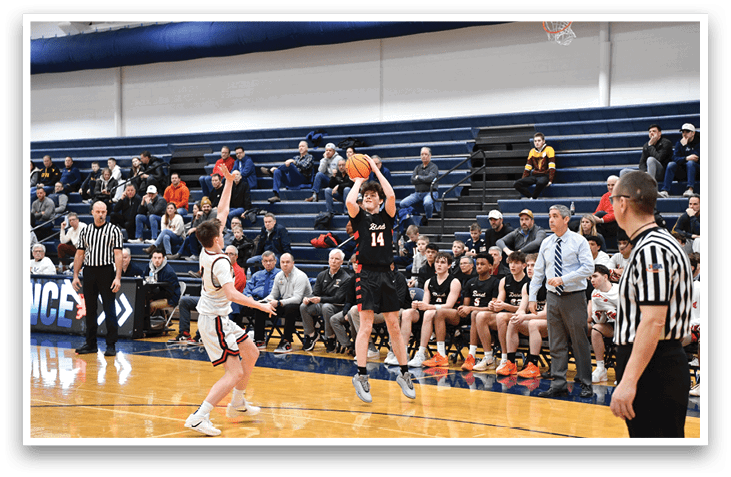 A basketball game is taking place with players on the court and spectators in the stands. One player is attempting to shoot the ball while others are watching. The scene includes a referee and a coach, as well as a few other people in the background. AI generated content