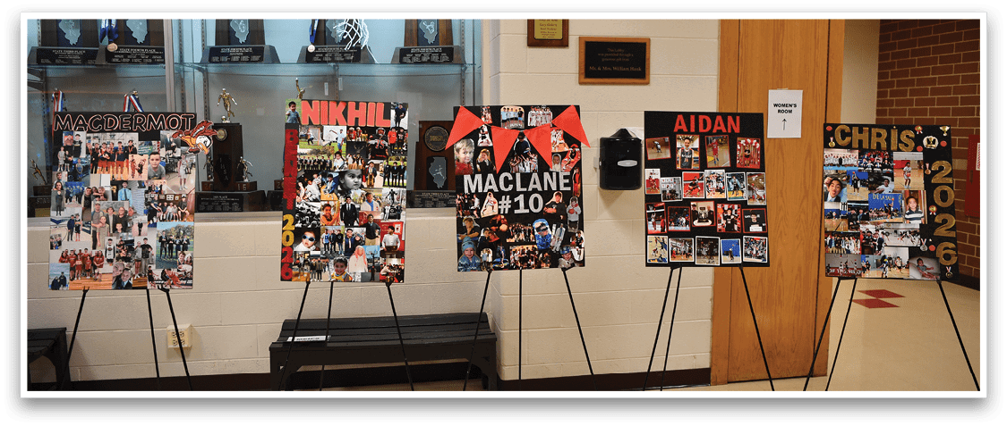 Three posters are displayed on stands in a hallway, featuring photos of people. AI generated content