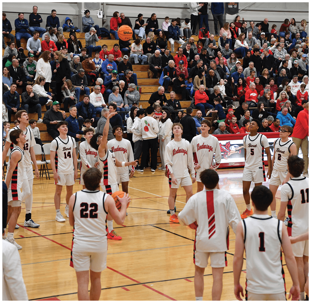 A group of young men playing basketball in front of a crowd. AI generated content