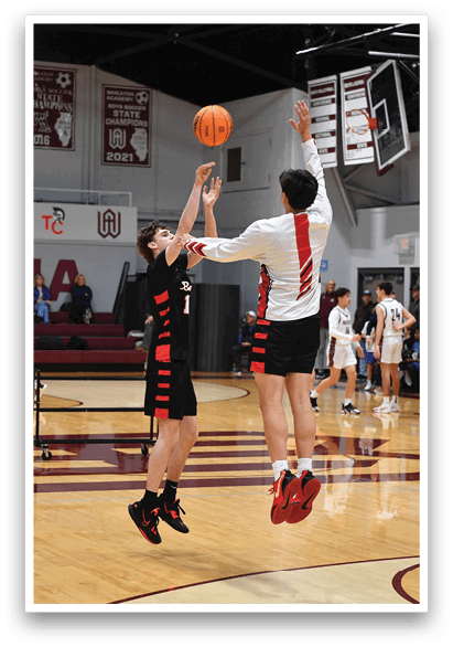Two basketball players jumping for the ball in a gym. AI generated content