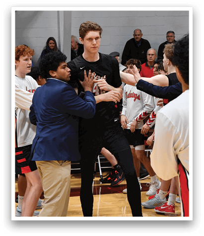 A group of young men are on a basketball court, some of them wearing red and white uniforms. They are shaking hands with each other, displaying sportsmanship. AI generated content