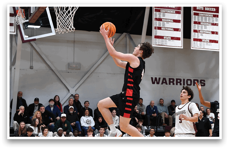 A basketball game is in progress with players on the court. A man is jumping to catch the ball while others are running around. The crowd watches from the sidelines. AI generated content