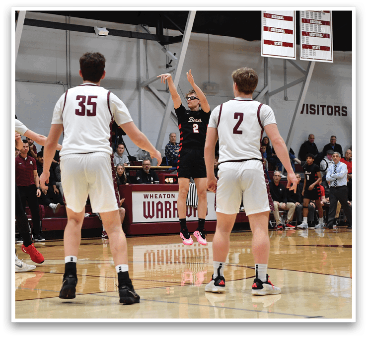 A basketball game is taking place with players on the court. A man is in the air attempting to shoot the ball. The crowd is watching the game intently. AI generated content