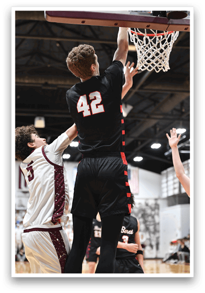 Two basketball players are leaping for the same ball, with one player wearing a black jersey with the number 42. AI generated content