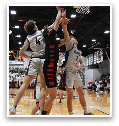 Three men are playing basketball, with one player jumping to block a shot. AI generated content