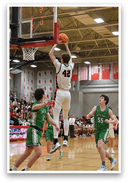 A basketball game is taking place with a player jumping to shoot the ball. The crowd is watching intently as the players compete. AI generated content