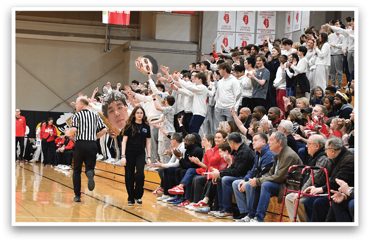 A basketball player in a red and white striped uniform is reaching up to shoot a basket. AI generated content