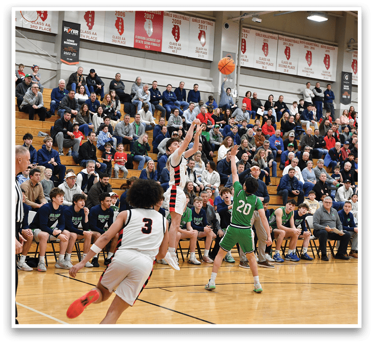 A basketball game is taking place with a crowd of people watching. One player is attempting to shoot the ball while others are waiting for the outcome. The spectators are seated on chairs surrounding the court. AI generated content