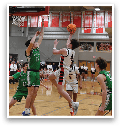 A basketball game is in progress with a player attempting to block a shot. AI generated content