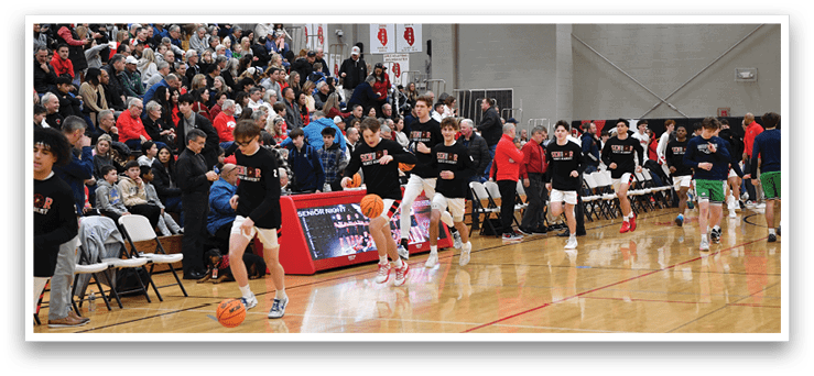 A group of young men playing basketball in a gym. AI generated content