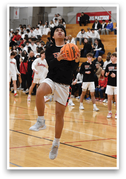A basketball game is taking place with a player jumping to shoot the ball. The crowd is watching the game intently. AI generated content