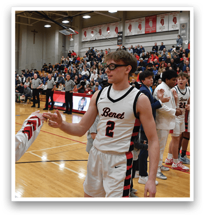 Two men shake hands on a basketball court, surrounded by a crowd of people. AI generated content