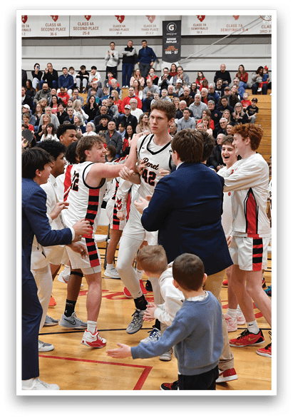 A group of young men celebrating a victory on a basketball court. AI generated content