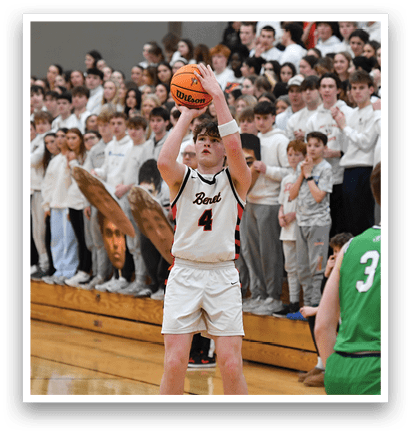 A basketball game is in progress with a player in a white uniform holding a basketball. The crowd is watching the game intently. AI generated content