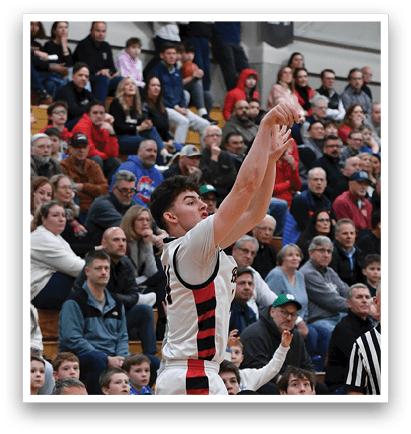 A basketball game is taking place with a player in the air attempting to shoot the ball. The crowd is watching intently as the player jumps. AI generated content