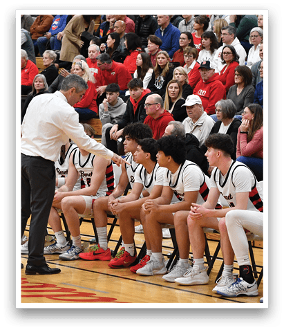 A group of people are sitting on chairs in a gym, watching a referee and a coach. AI generated content