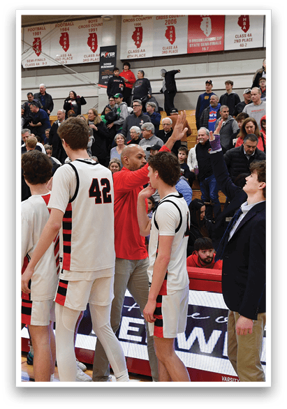 A group of young men in uniforms are standing on a basketball court, waving to the crowd. AI generated content