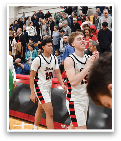 A group of young men are playing basketball in front of a crowd. AI generated content