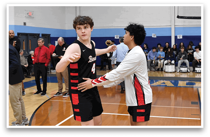 Two men in basketball uniforms are shaking hands on the court. AI generated content
