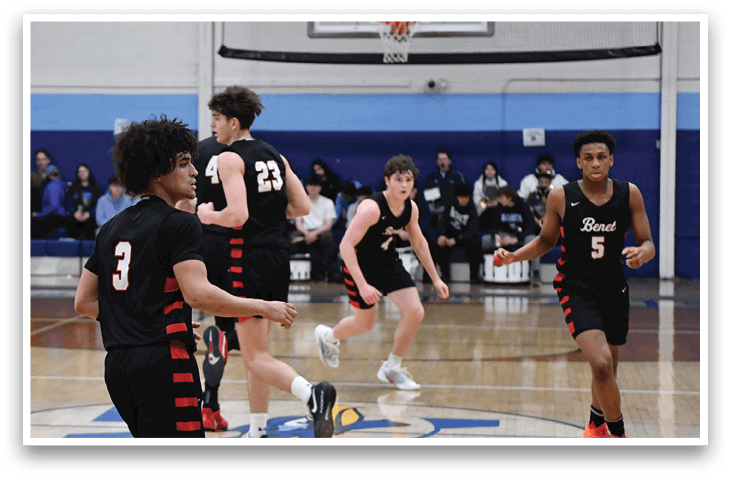 A group of young men playing basketball on a court. AI generated content
