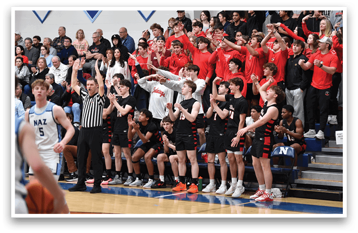 A group of people in a gym, some are wearing red shirts and others are wearing black. A referee is present, and a basketball is visible in the scene. AI generated content