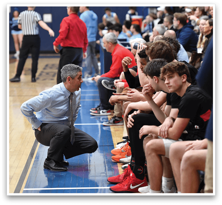 A man is kneeling down on a basketball court, talking to a group of young men. AI generated content