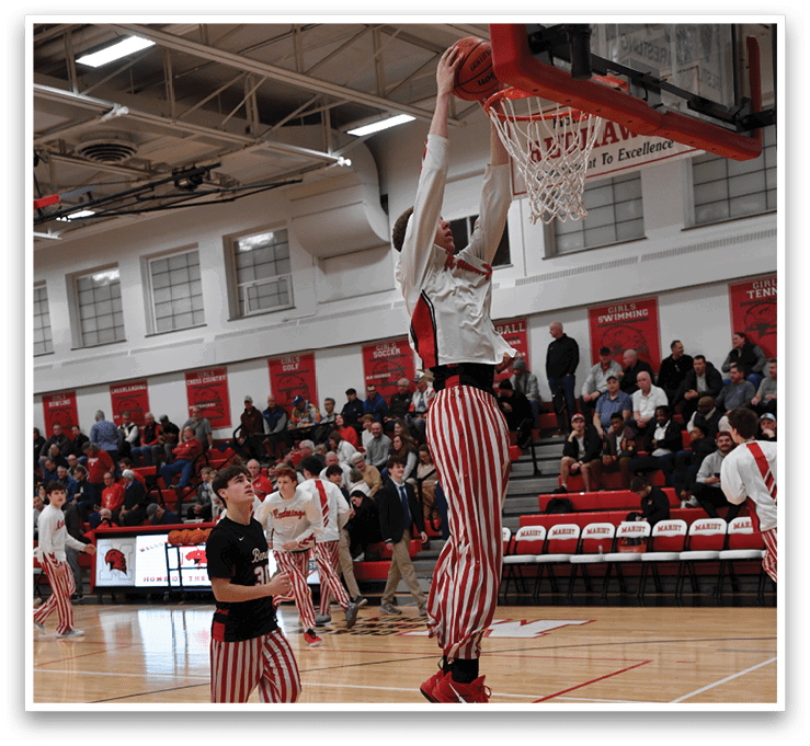 A basketball game is taking place with a group of men playing. One man is jumping to hit the basketball while others are watching. The crowd is watching the game from the stands. AI generated content