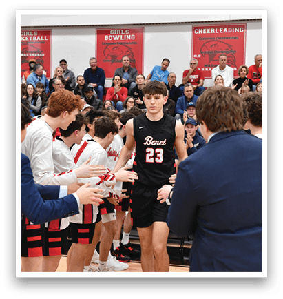 A group of people are gathered around a basketball player, shaking his hand and congratulating him. The player is wearing a black jersey with the number 23 on it. AI generated content