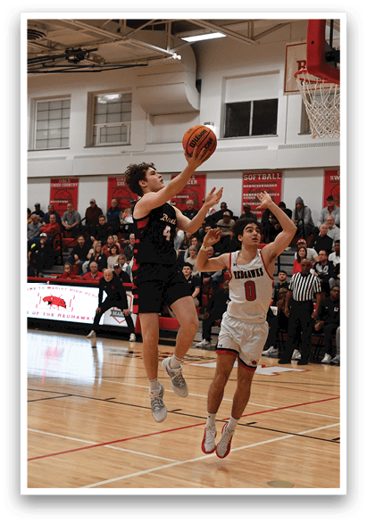 A basketball game is in progress with a player jumping to block a shot. AI generated content