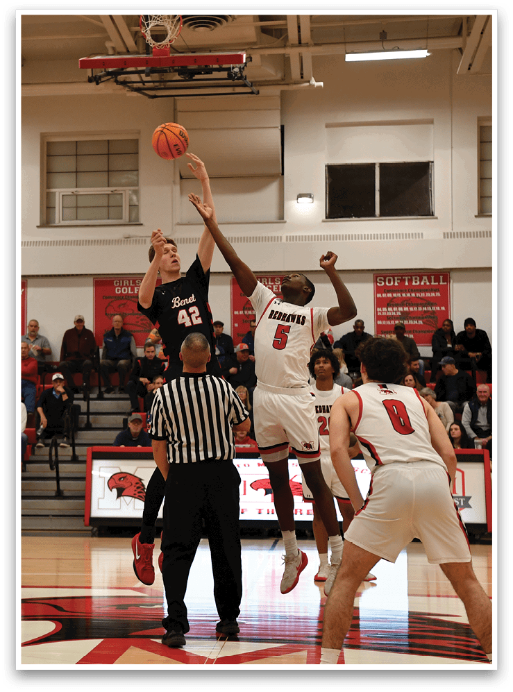 A group of men playing basketball on a court. One man is jumping to block a shot. AI generated content