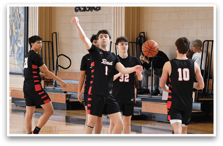 A group of young men playing basketball in a gym. AI generated content